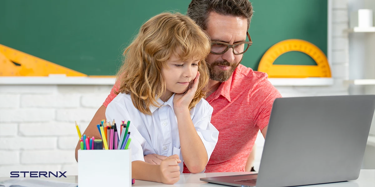 Teacher helping student at blackboard: A teacher provides individual support as she points at equations on the blackboard to help a student solve a math problem